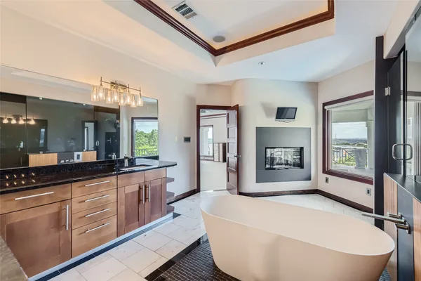 a bathroom with a sink a mirror and a shower