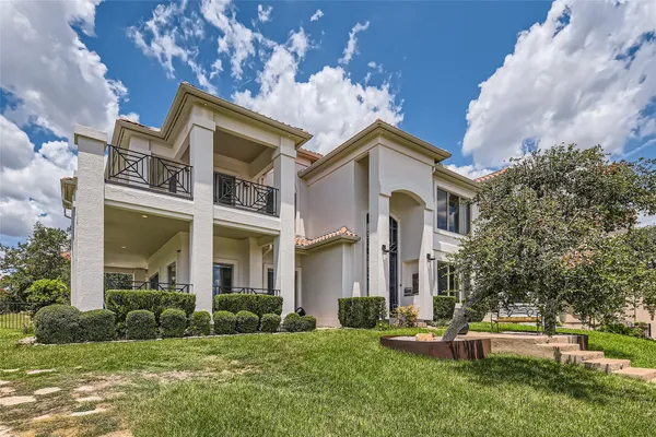 an aerial view of a house with garden space and street view