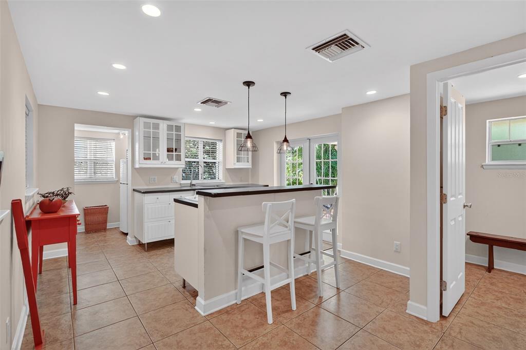 617 Robie Avenue Mount Dora, FL 32757 - Photo 13 of 26 a kitchen with stainless steel appliances kitchen island granite countertop a table and chairs in it