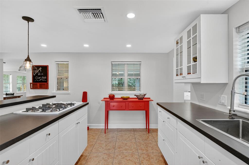 617 Robie Avenue Mount Dora, FL 32757 - Photo 14 of 26 a kitchen with stainless steel appliances granite countertop a sink stove and cabinets