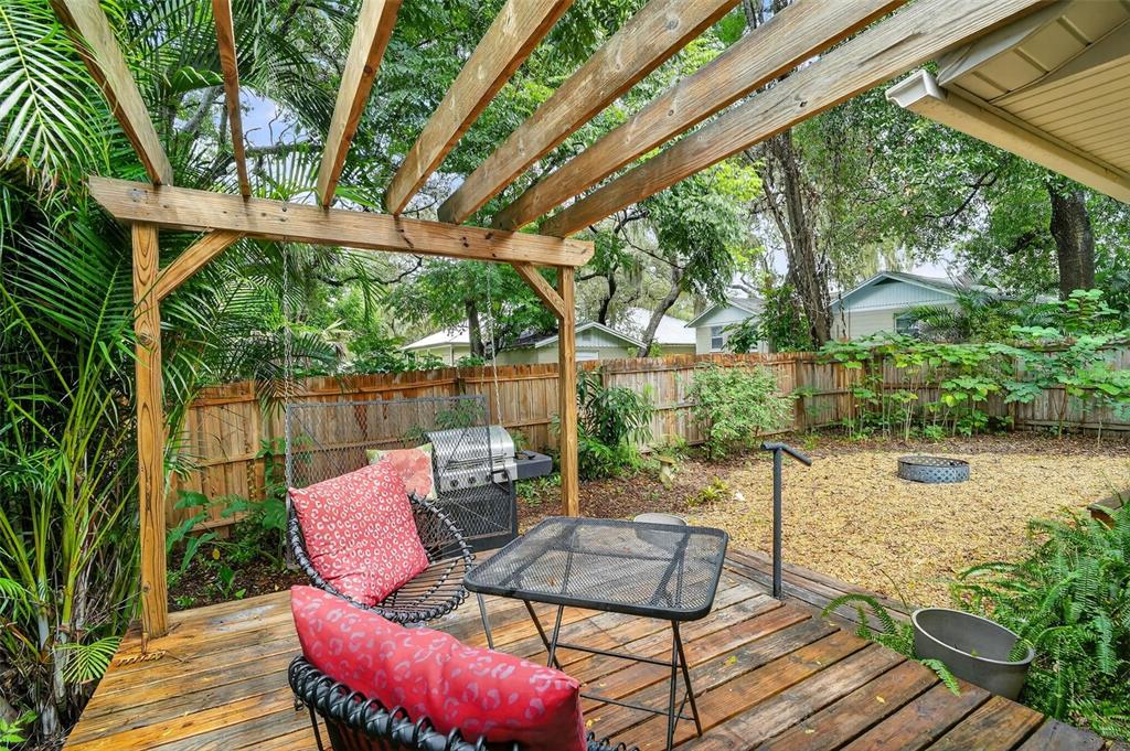 617 Robie Avenue Mount Dora, FL 32757 - Photo 21 of 26 a view of a patio with a table chairs and a backyard
