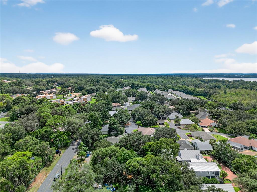 617 Robie Avenue Mount Dora, FL 32757 - Photo 23 of 26 an aerial view of residential houses with outdoor space and trees