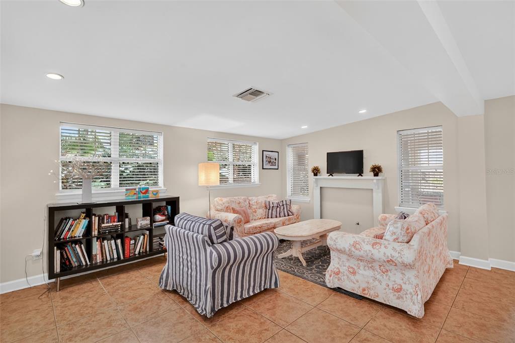 617 Robie Avenue Mount Dora, FL 32757 - Photo 9 of 26 a living room with furniture and a flat screen tv