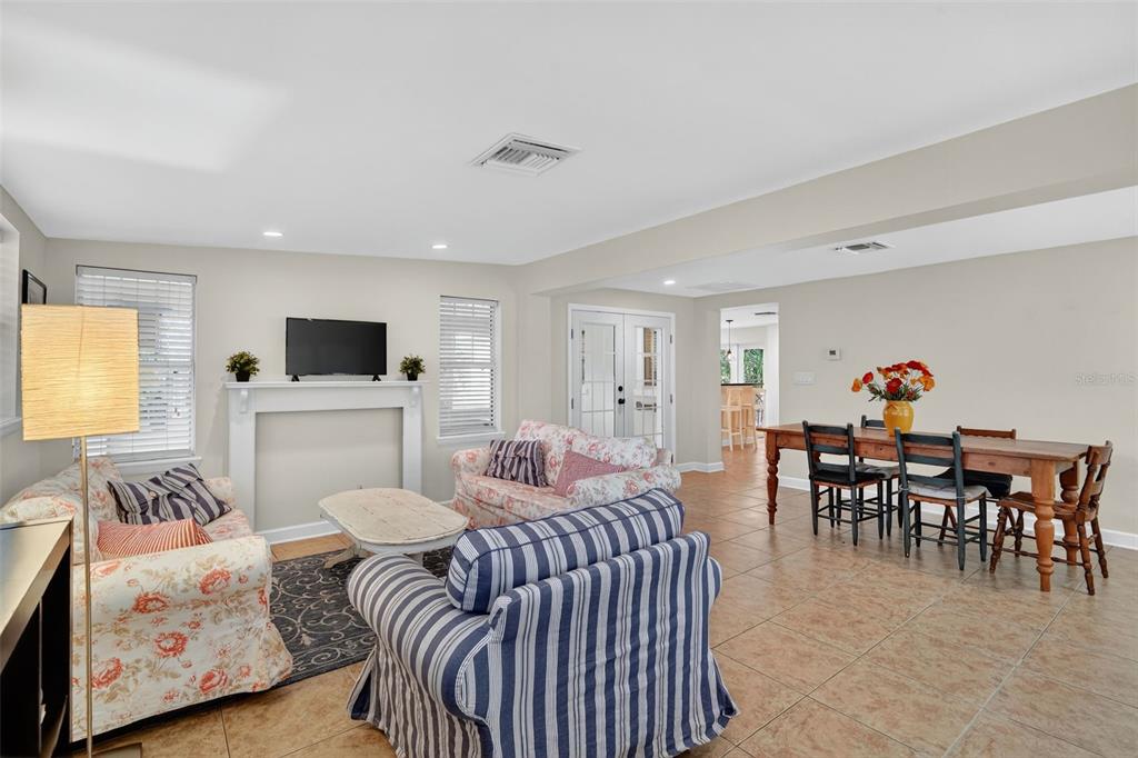 617 Robie Avenue Mount Dora, FL 32757 - Photo 10 of 26 a living room with furniture and a flat screen tv