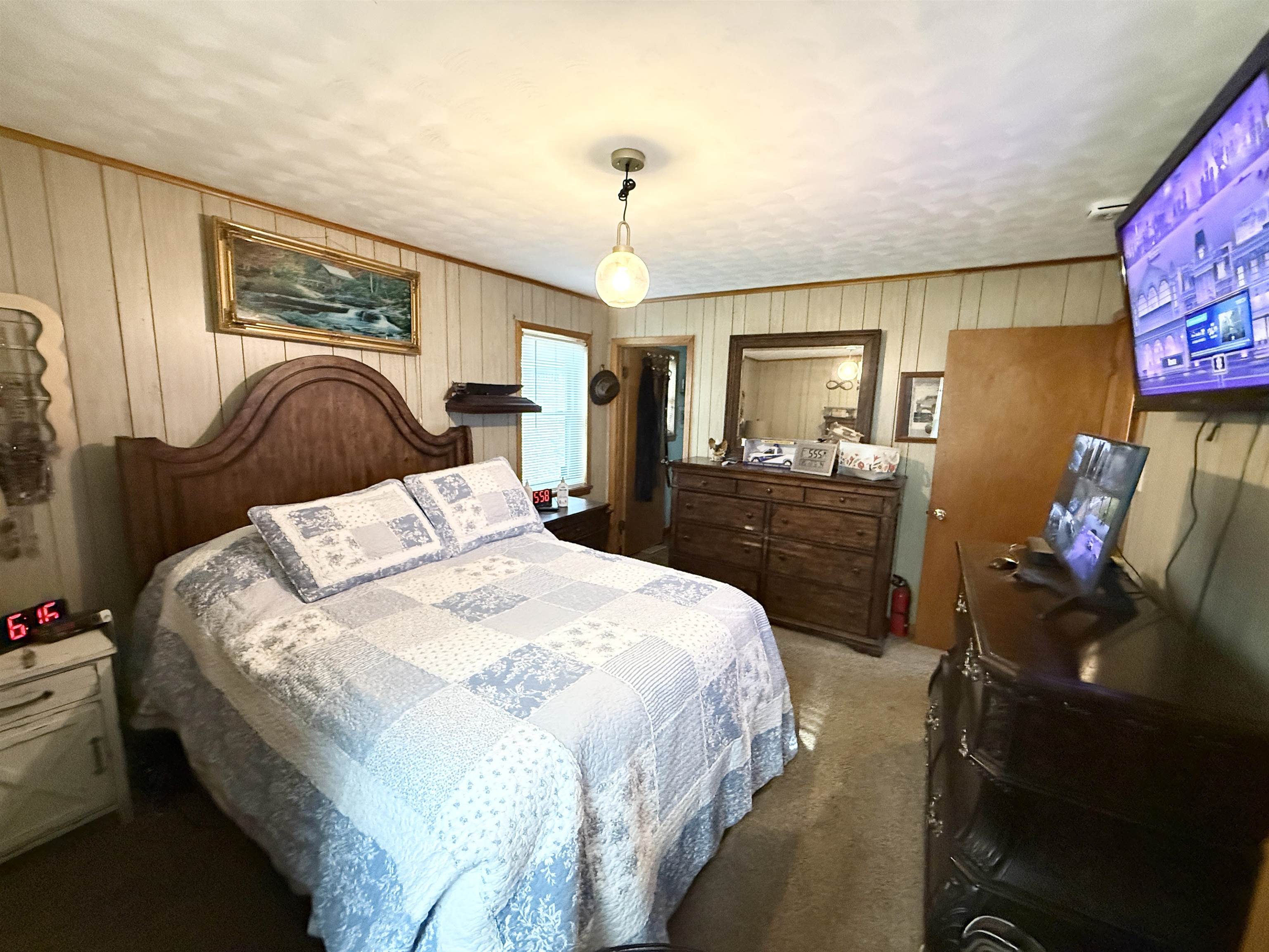 127 Harvey Newman Road Gates, TN 38037 - Photo 18 of 40 a bedroom with a bed and a chandelier