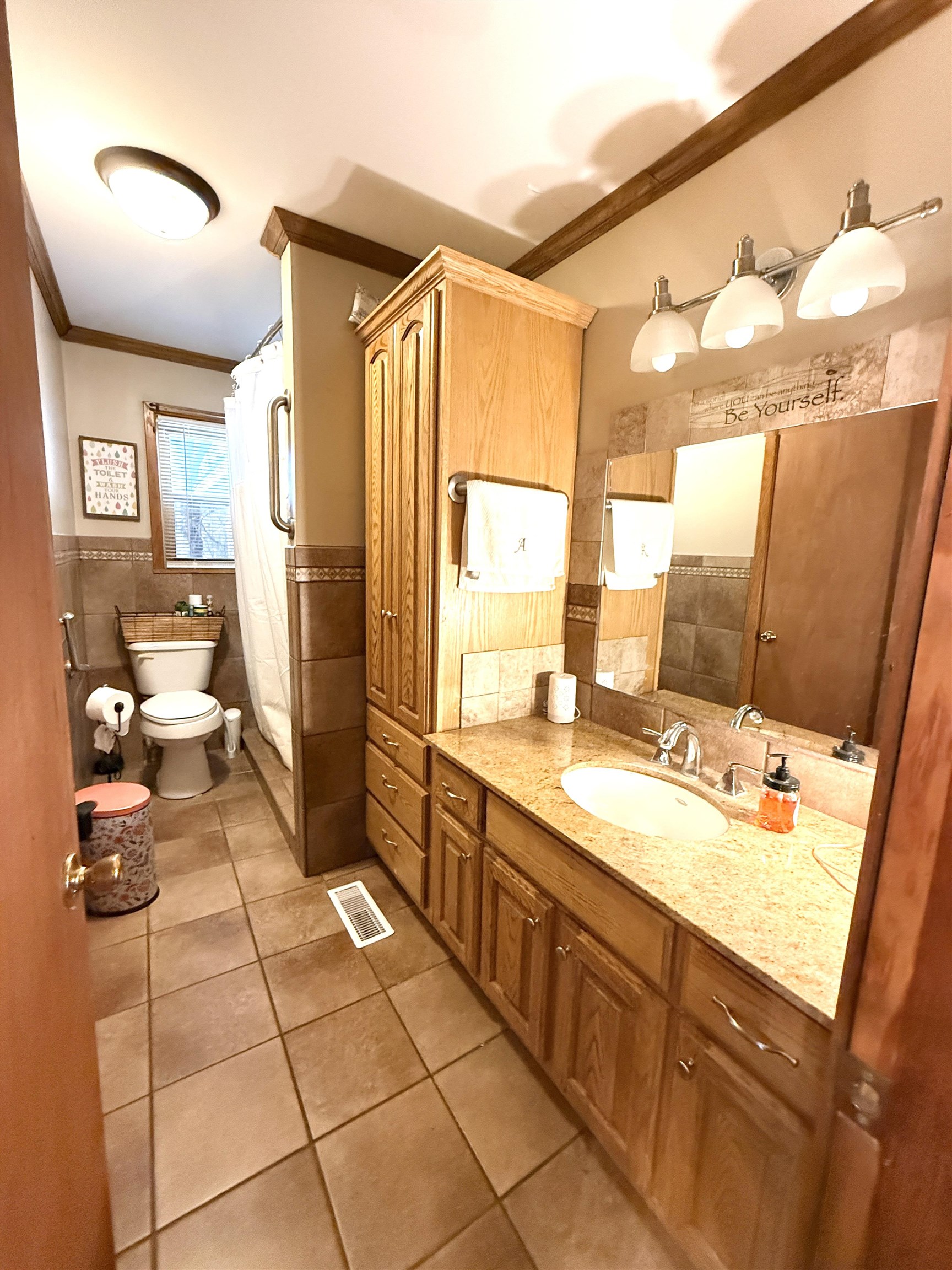 127 Harvey Newman Road Gates, TN 38037 - Photo 19 of 40 a bathroom with a sink mirror and a shower