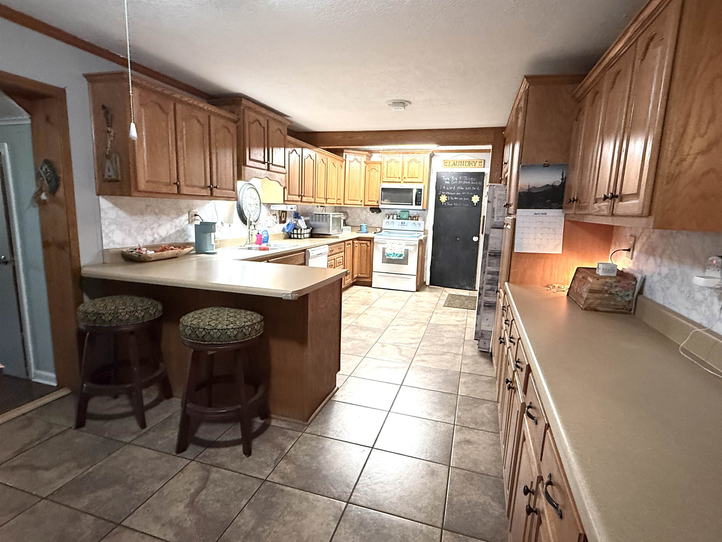 127 Harvey Newman Road Gates, TN 38037 - Photo 10 of 40 a kitchen with stainless steel appliances granite countertop a sink counter space and cabinets