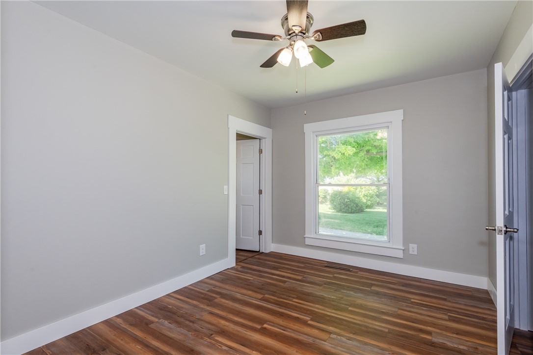 1217 Jasper Road Xenia, OH 45385 - Photo 36 of 62 This airy bedroom features rich hardwood flooring and a bright window overlooking green outdoor space.
