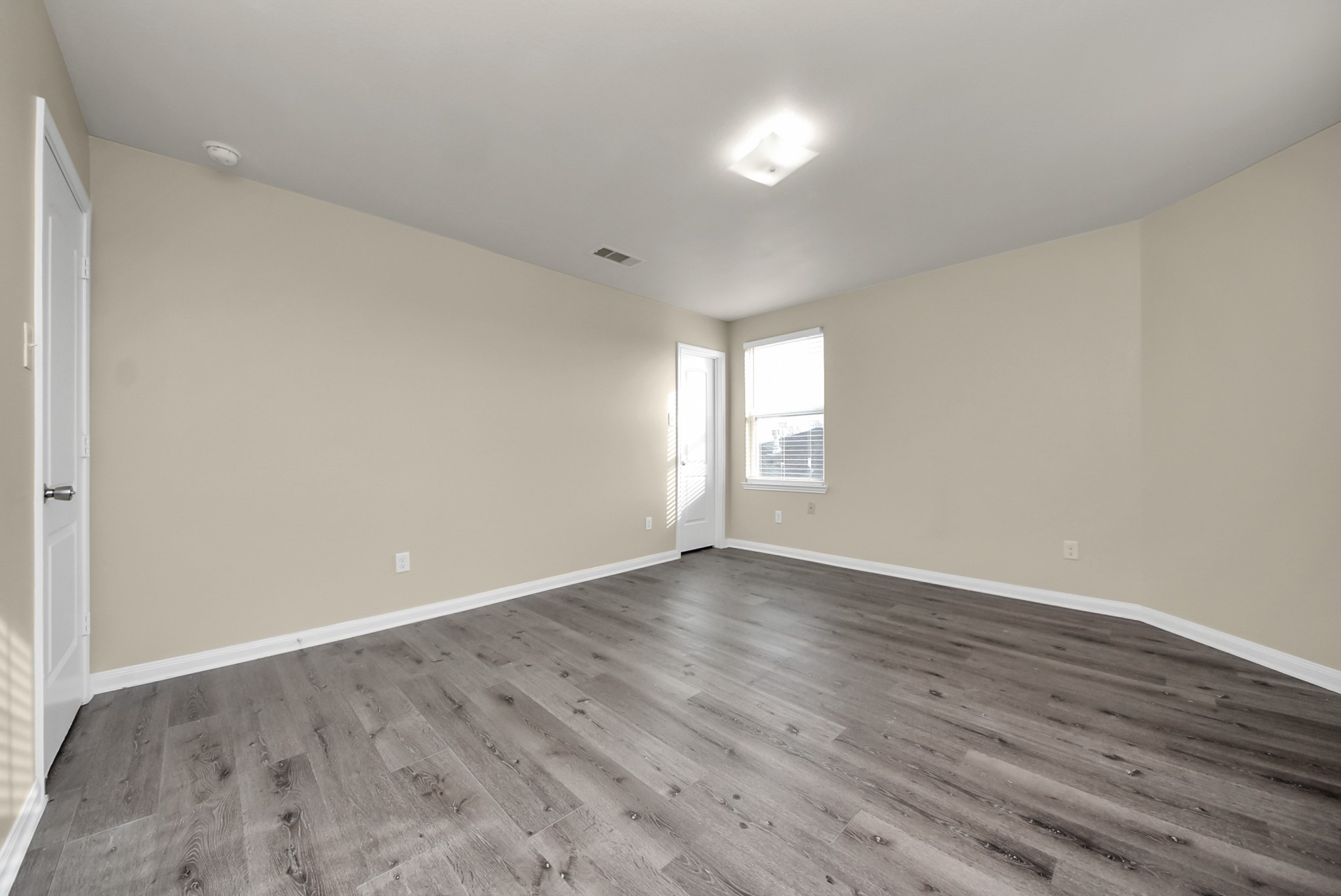 1855 Garnet Breeze Drive Rosharon, TX 77583 - Photo 31 of 40 a view of an empty room with wooden floor and window