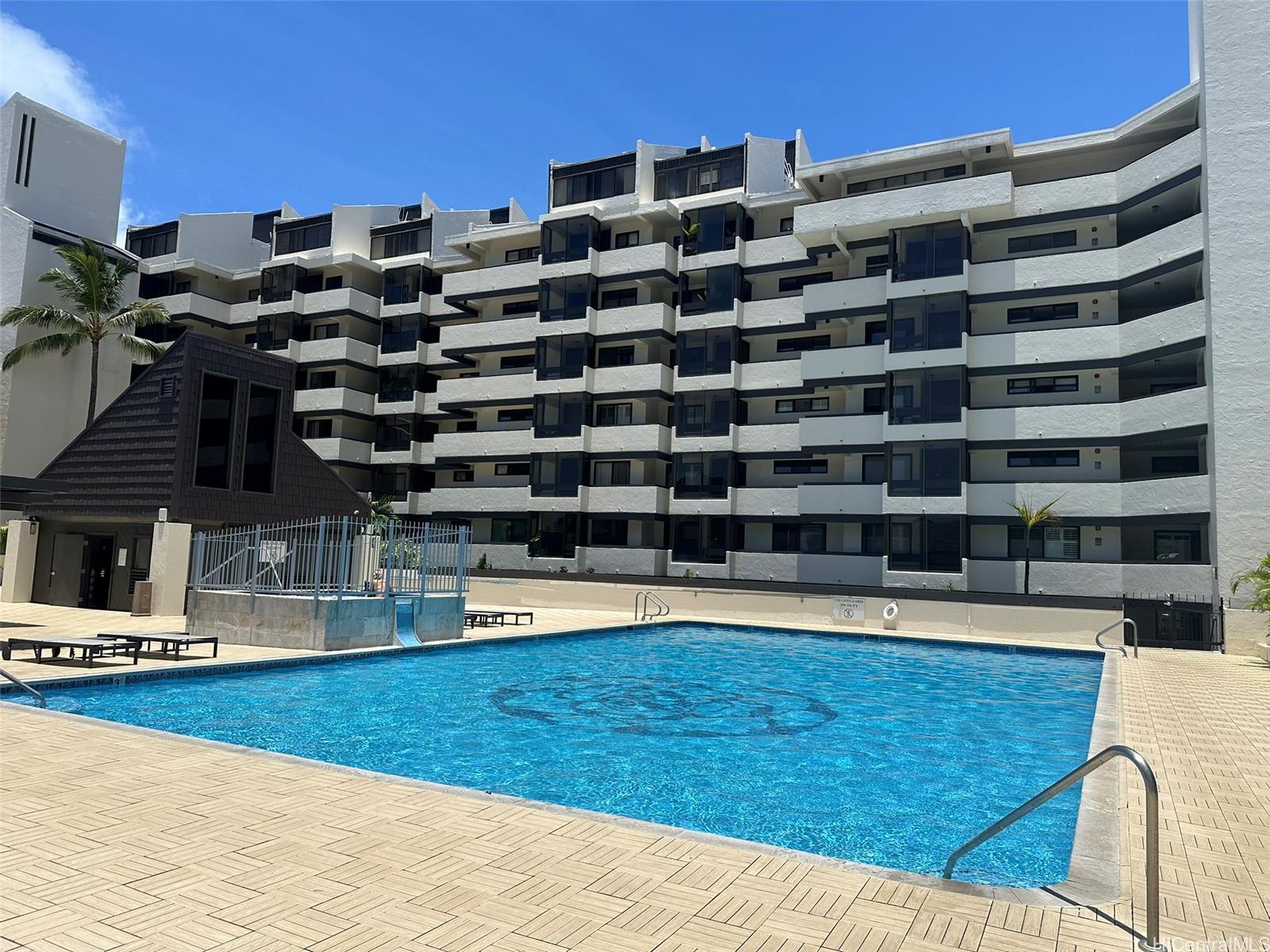 500 Lunalilo Home Road, Unit 22C Honolulu, HI 96825 - Photo 18 of 25 Half an Olympic saltwater heated pool and spa with lounge chairs.