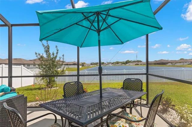 a view of a swimming pool with a lounge chairs and a table