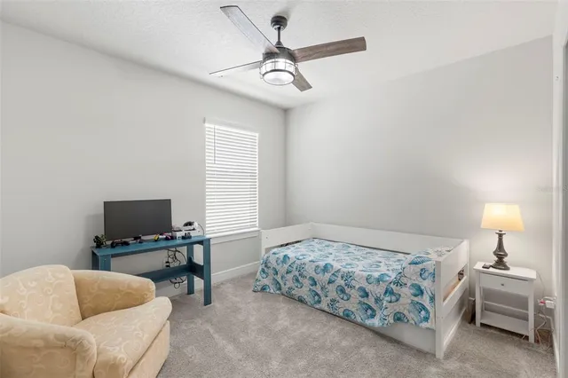 a bathroom with a granite countertop sink a toilet and a mirror