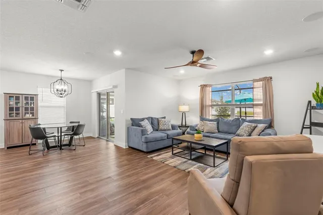 a living room with furniture and wooden floor
