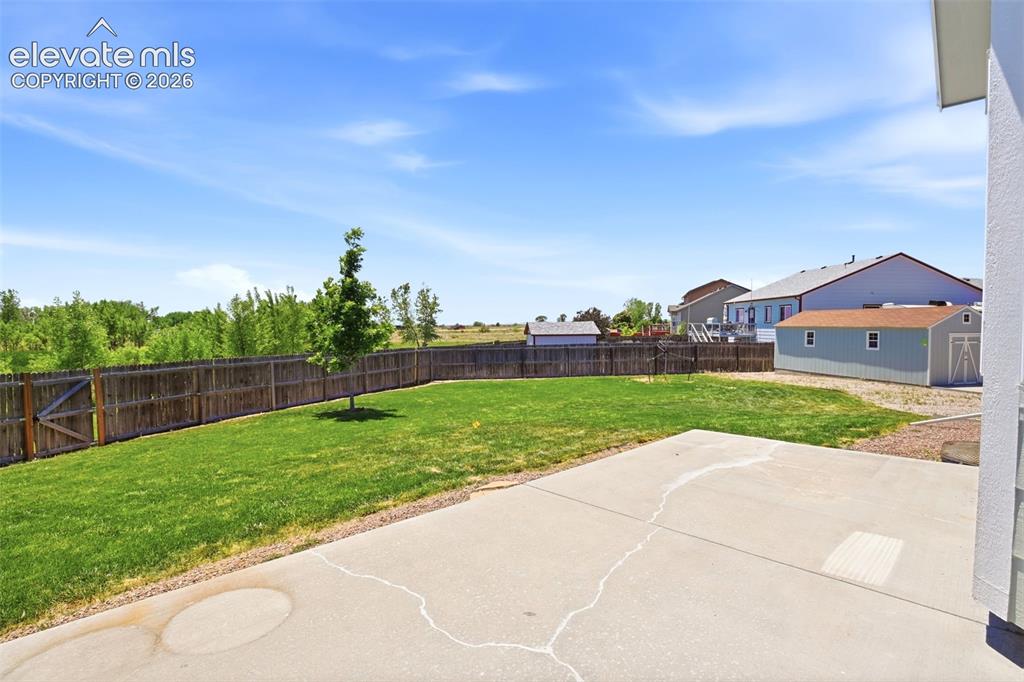 7806 Dutch Loop Colorado Springs, CO 80925 - Photo 29 of 41 a view of green field with house in the background