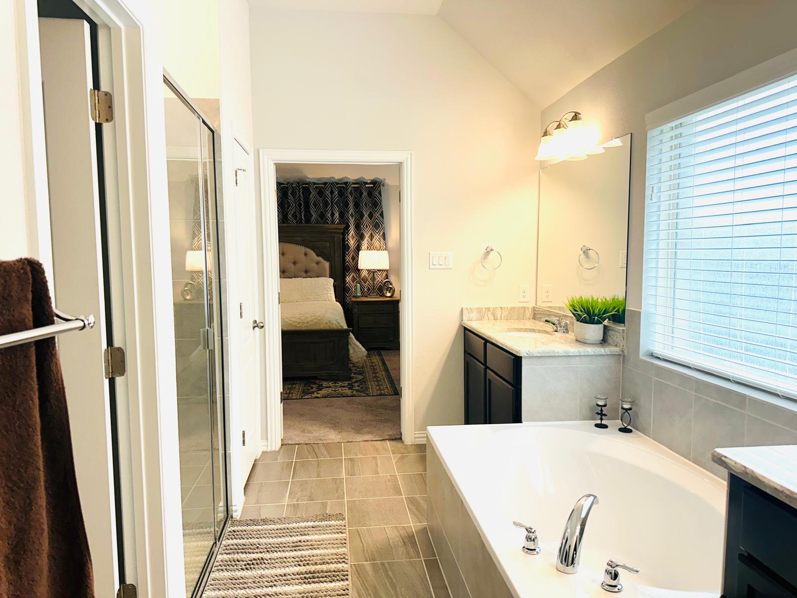 862 Leadtree Loop Buda, TX 78610 - Photo 24 of 40 a bathroom with a tub sink and shower