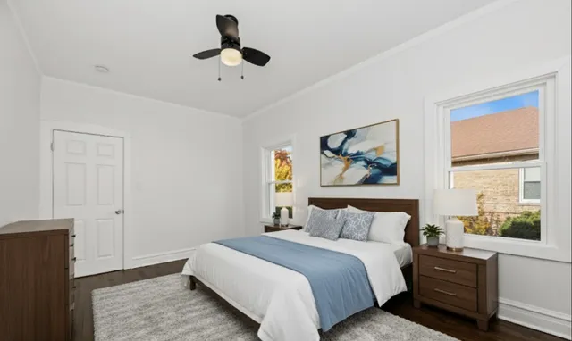 a view of empty room with wooden floor and window