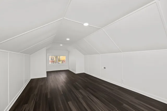 a view of a hallway and wooden floor with entryway