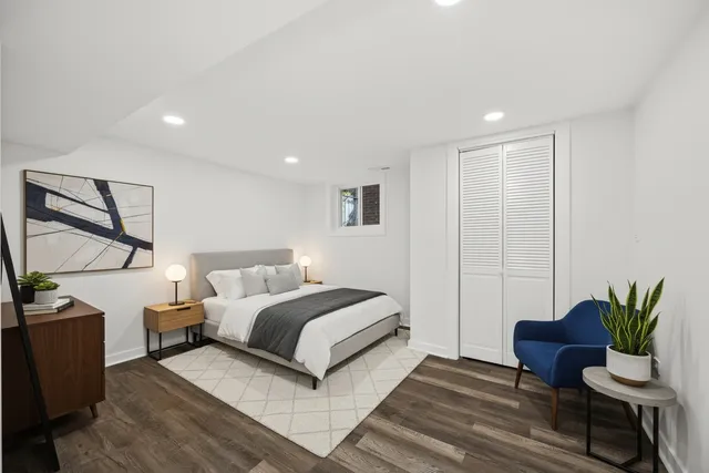 a bedroom with a bed and a potted plant