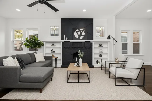 a living room with a fireplace and a floor to ceiling window