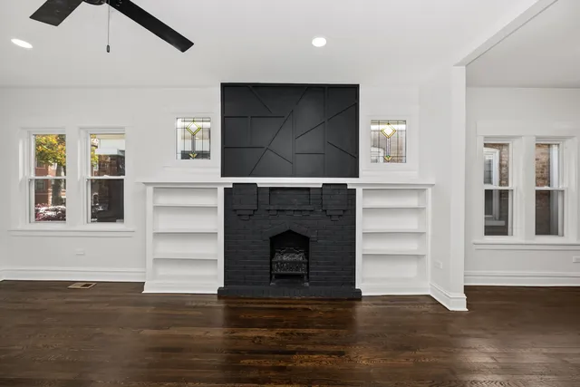 a living room with furniture a fireplace and window