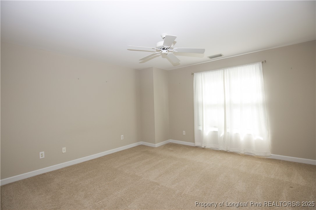 175 Knoll Road Southern Pines, NC 28387 - Photo 38 of 50 an empty room with windows and fan