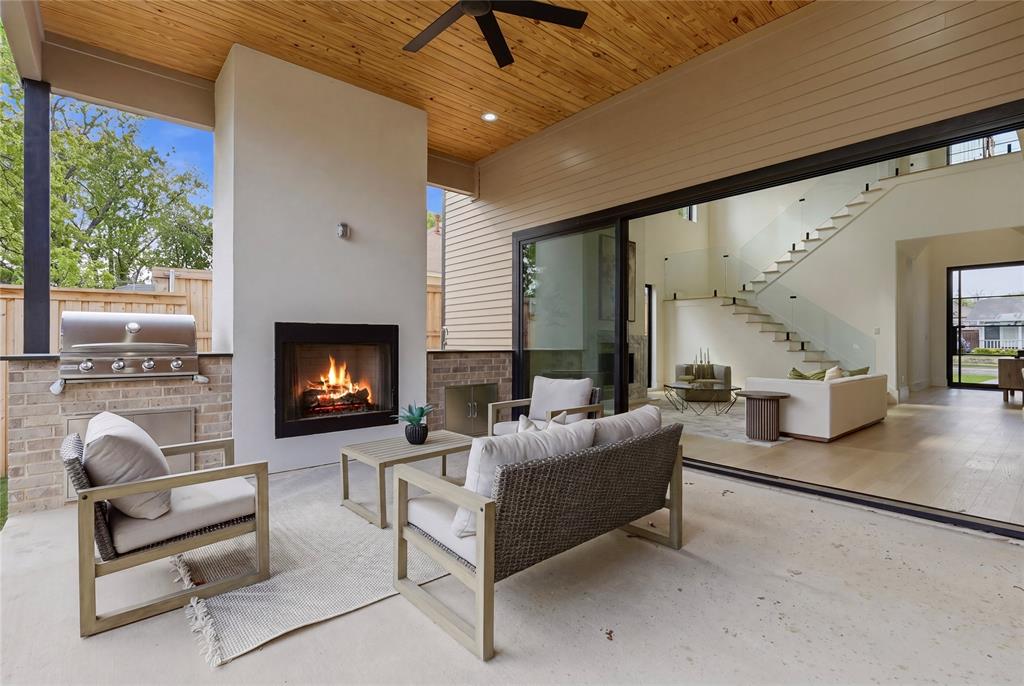 6038 Prospect Avenue Dallas, TX 75206 - Photo 23 of 40 Covered outdoor patio featuring a built-in fireplace and integrated grill station