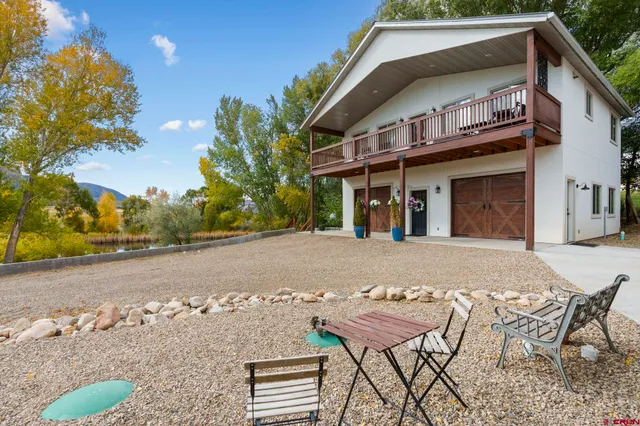 a view of a house with backyard and sitting area