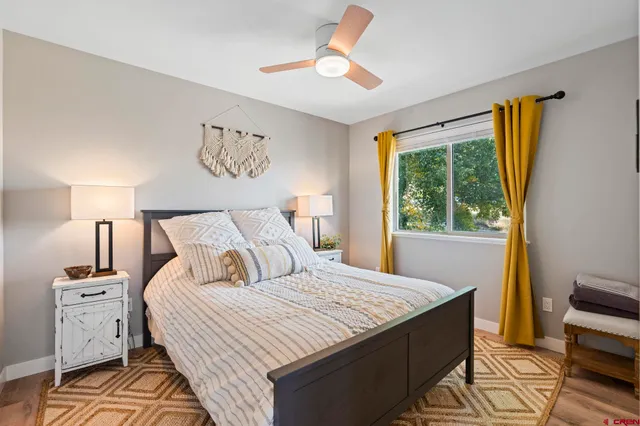 a bedroom with a large bed and a window