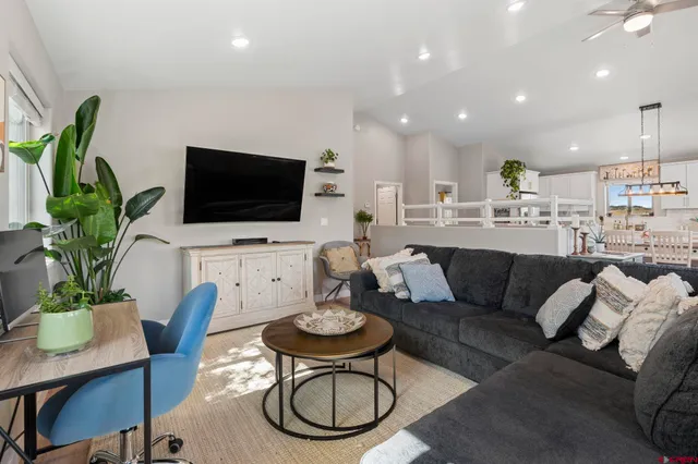 a living room with furniture a rug and a flat screen tv
