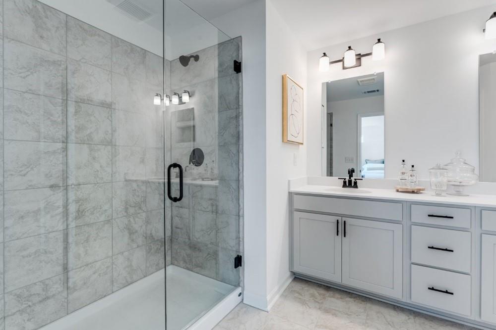 3197 Eastham Run Drive Dacula, GA 30019 - Photo 27 of 34 a bathroom with a double vanity sink mirror and shower