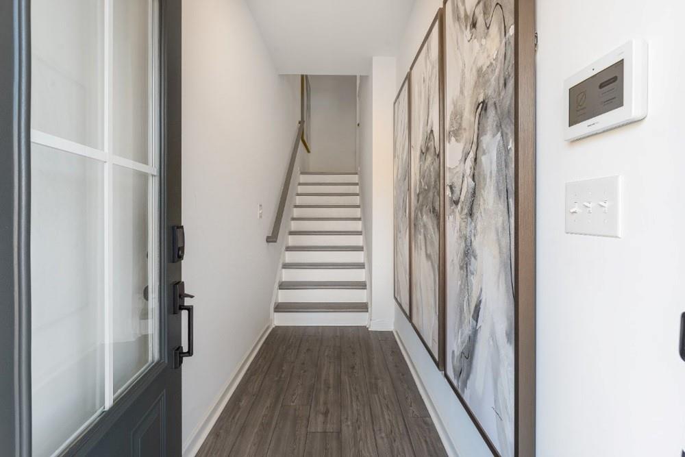 3197 Eastham Run Drive Dacula, GA 30019 - Photo 6 of 34 a view of a hallway with wooden floor and staircase