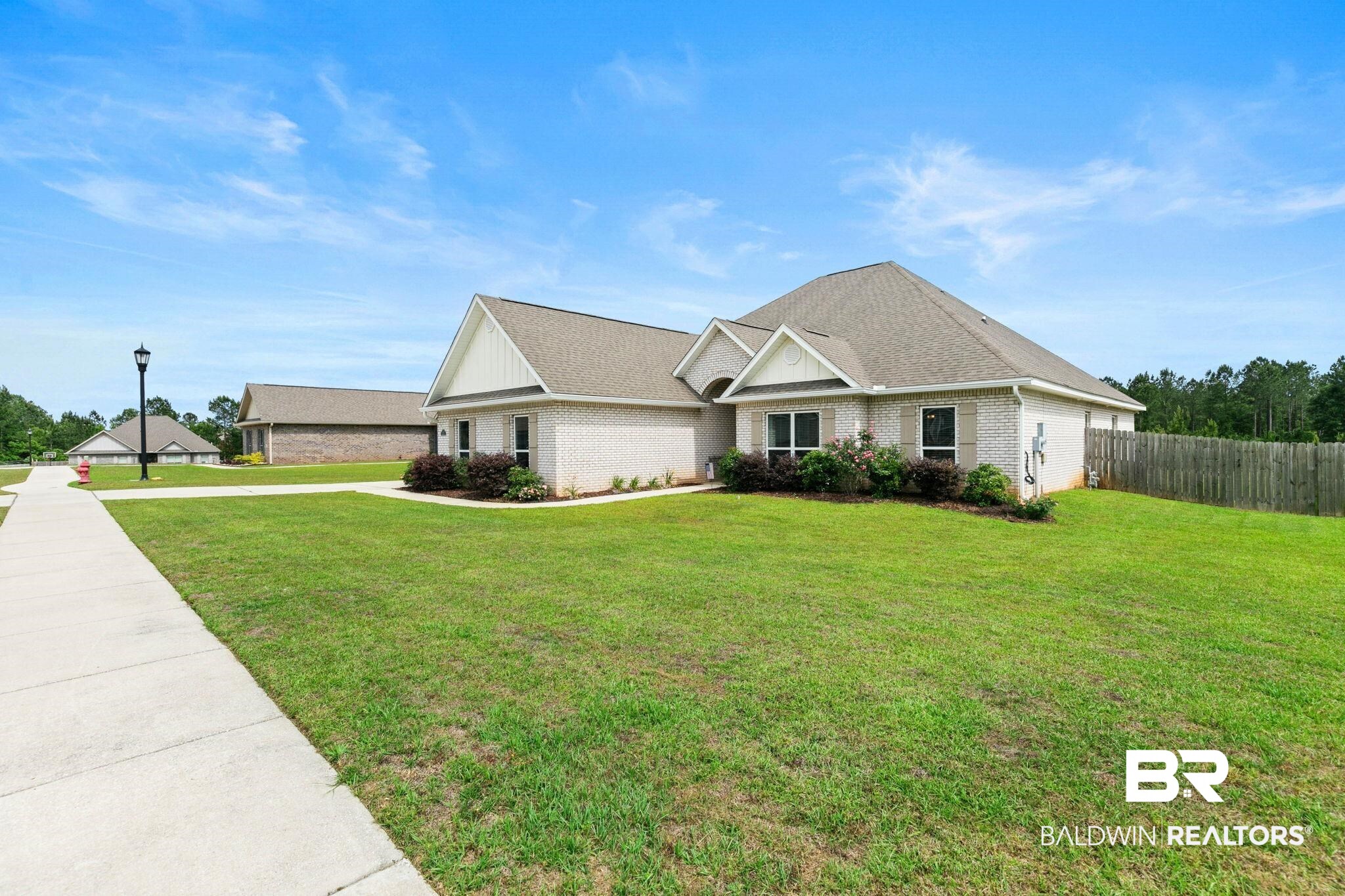 31187 Spoonbill Road Daphne, AL 36527 - Photo 63 of 85 Light brick exterior with white trim and a gabled roofline