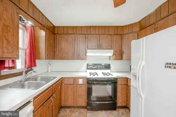 a kitchen with a refrigerator and a sink