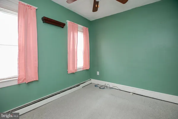a view of a room that has a window and a fan