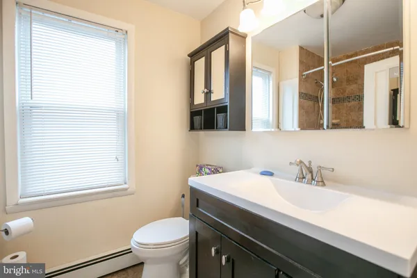 a bathroom with a sink a toilet and a mirror