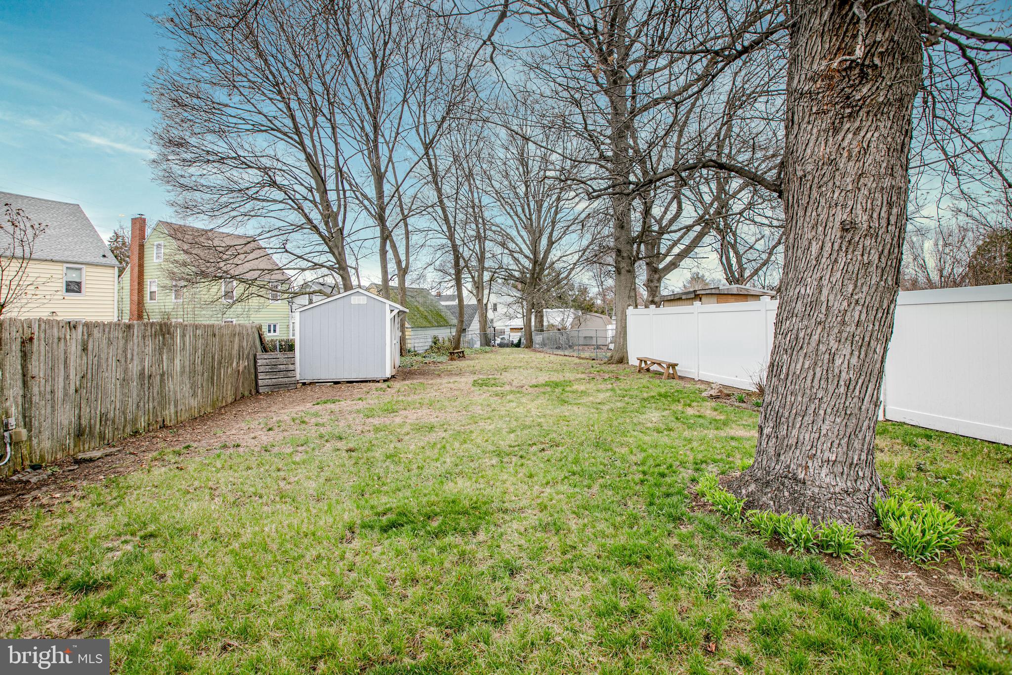 2414 Hamilton Avenue Hamilton, NJ 08619 - Photo 30 of 31 a backyard of a house with a large tree and wooden fence