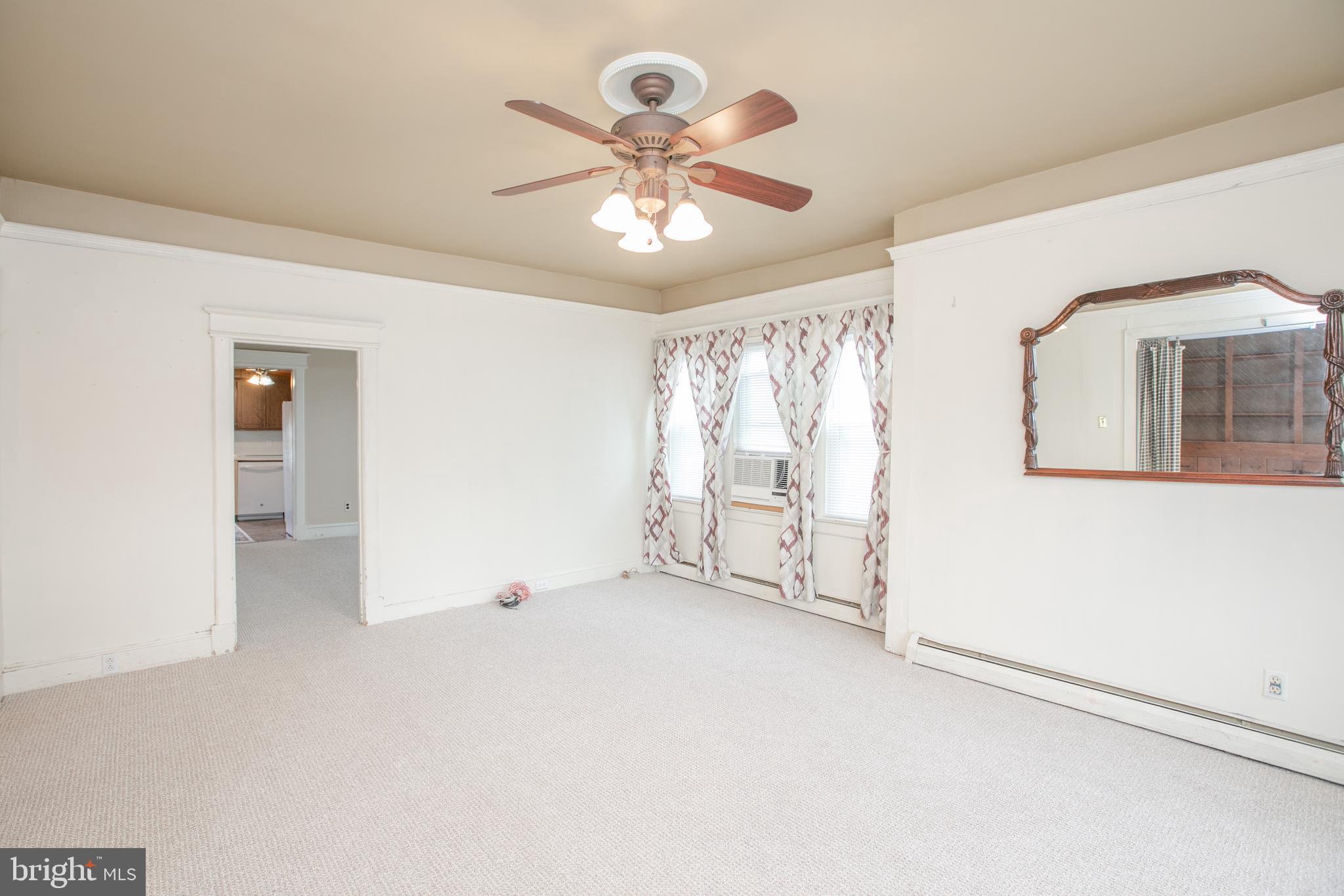 2414 Hamilton Avenue Hamilton, NJ 08619 - Photo 3 of 31 an empty room with chandelier fan and windows