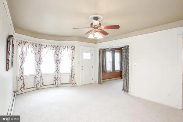 a view of room with window and ceiling fan