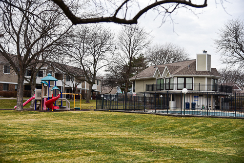 1560 7 Pines Road, Unit C1 Schaumburg, IL 60193 - Photo 15 of 17 a view of a swimming pool with a yard in the background