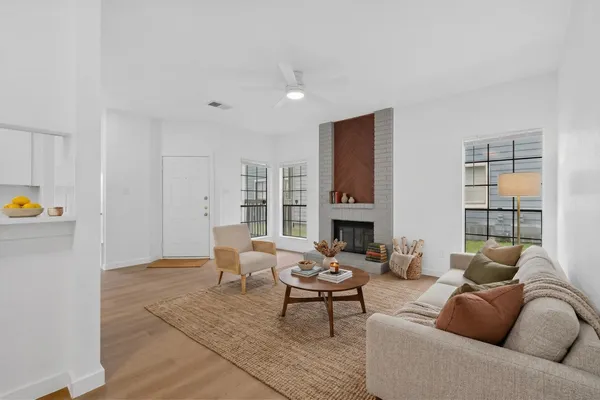 a living room with furniture and a fireplace