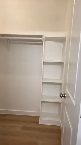 a view of walk in closet with empty racks