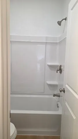 a bathroom with a bathtub and a toilet