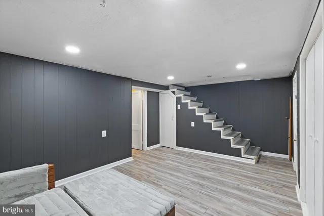 a room with a bed and wooden floor