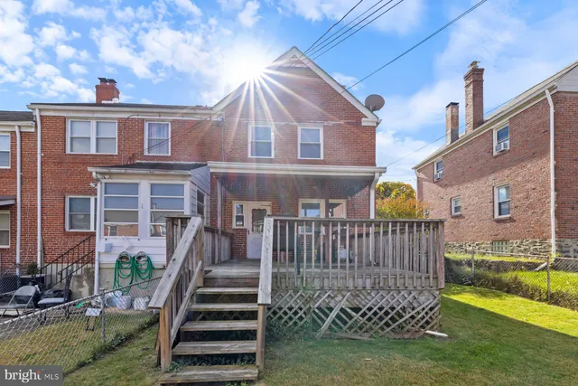 a view of a house with a yard and deck