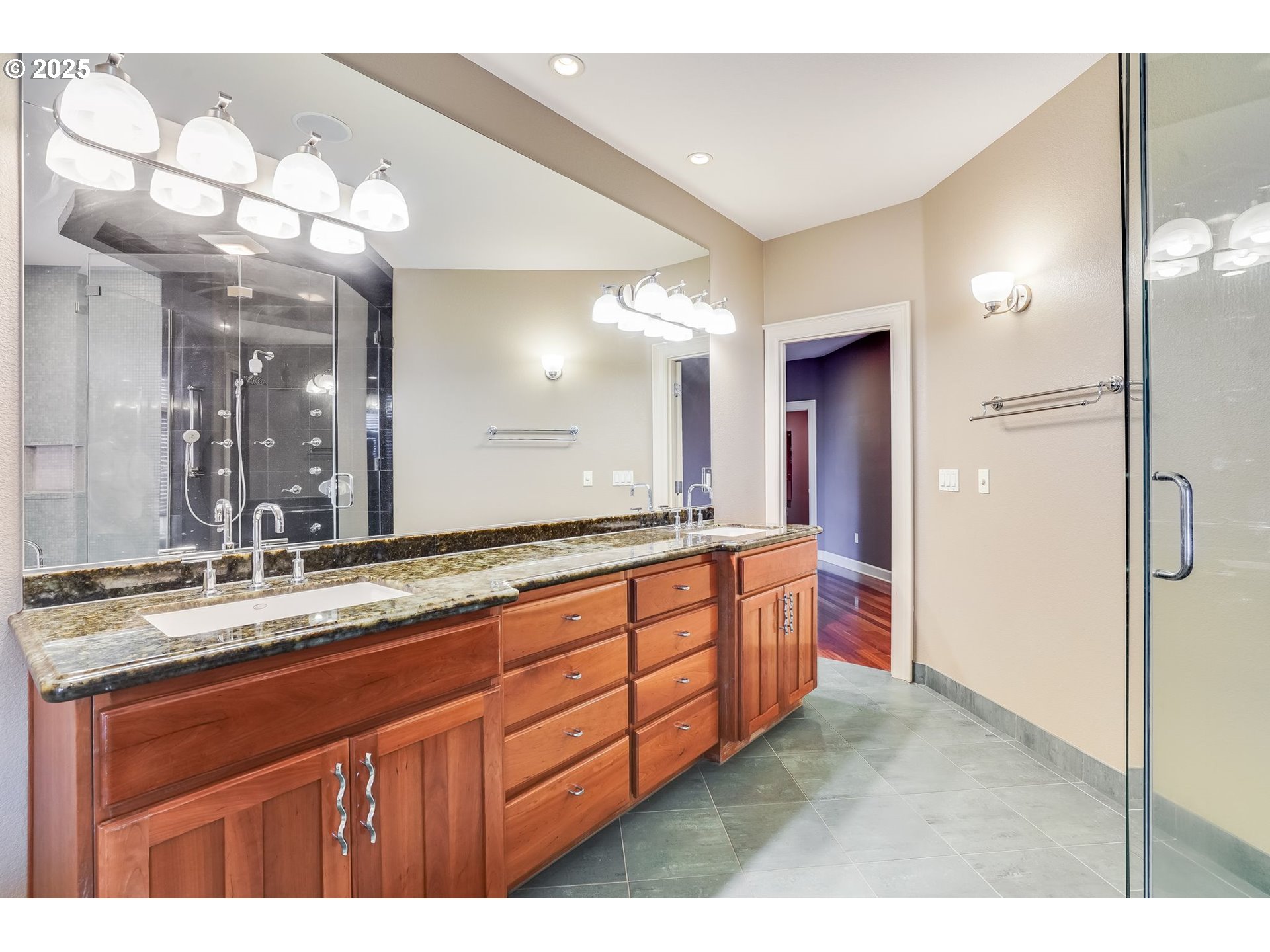 9309 Northwest Finzer Court Portland, OR 97229 - Photo 18 of 43 a bathroom with a double vanity sink and a mirror