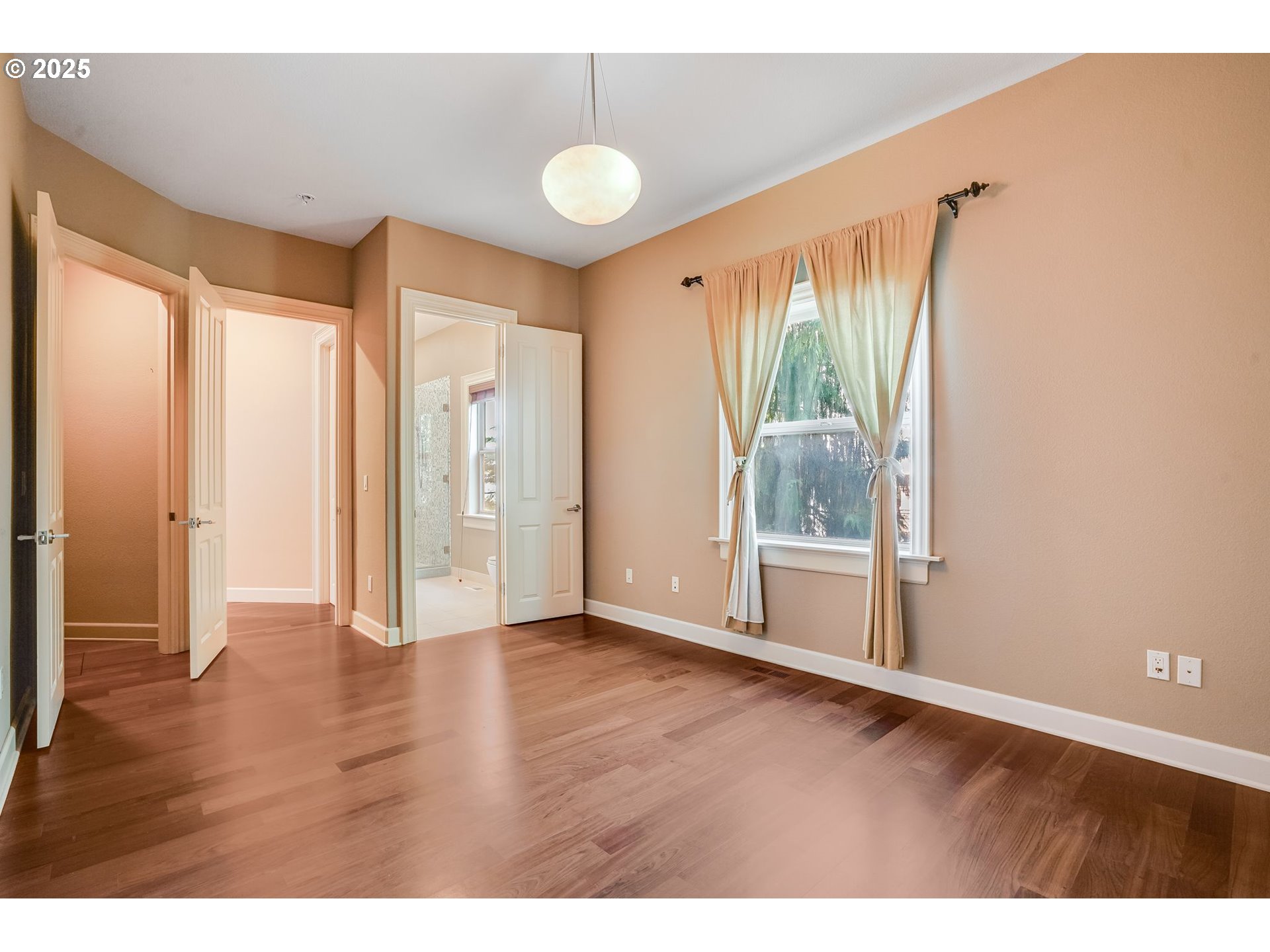 9309 Northwest Finzer Court Portland, OR 97229 - Photo 20 of 43 a view of an empty room with wooden floor and a window