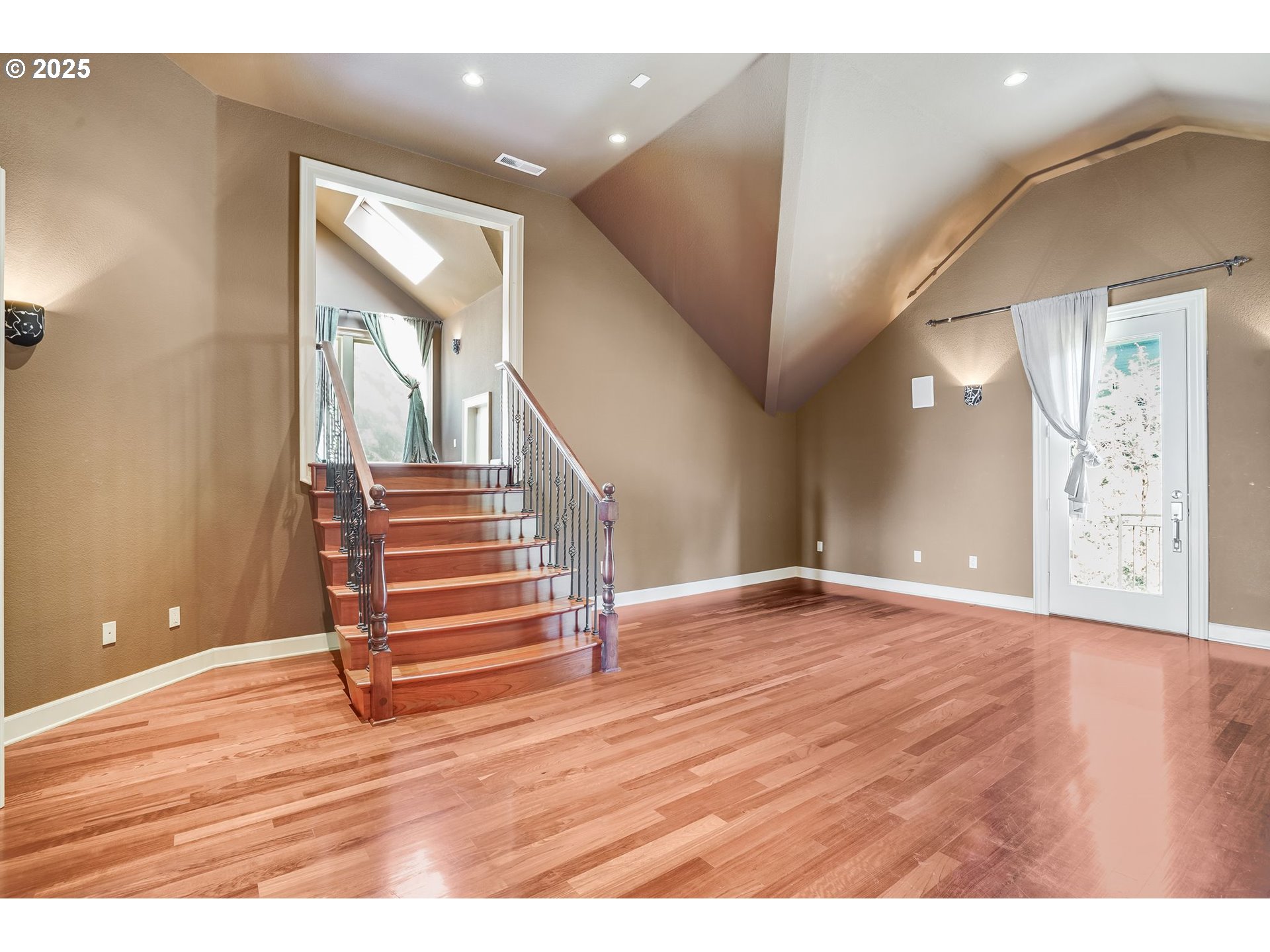9309 Northwest Finzer Court Portland, OR 97229 - Photo 25 of 43 a view of an empty room with wooden floor and stairs