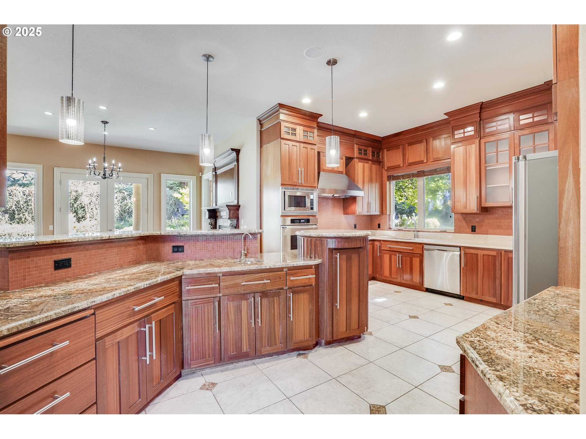 9309 Northwest Finzer Court Portland, OR 97229 - Photo 8 of 43 a large kitchen with stainless steel appliances kitchen island granite countertop a sink and cabinets
