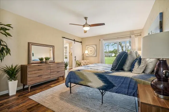 a bedroom with a bed and a lamp