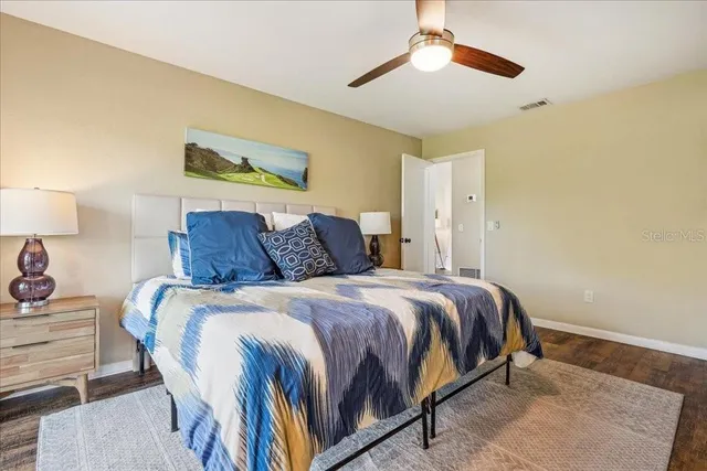 a spacious bathroom with double vanity a mirror and a shower